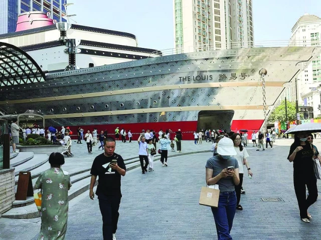 people walk in front of new lv store in shanghai photo reuters people walk in front of new lv store in shanghai photo reuters