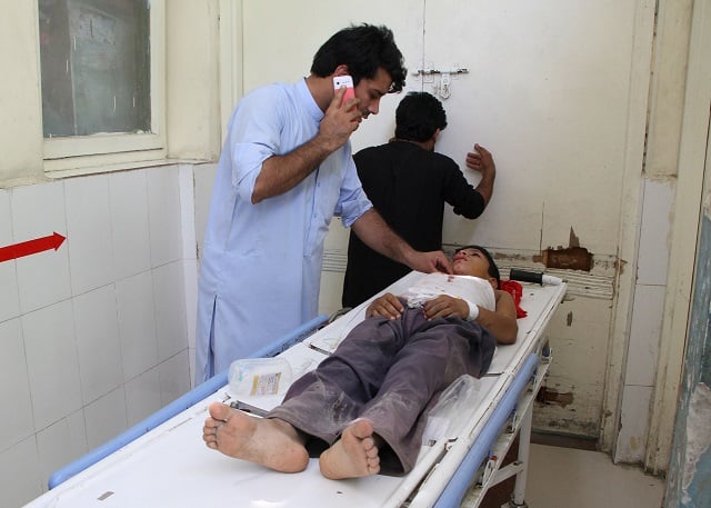 an afghan wounded boy receives treatment at a hospital following multiple explosions in jalalabad on september 11 2018 photo afp