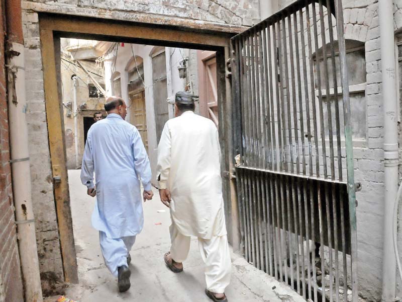 men walk through a gate in bhabra bazaar area photo agha mehroz express