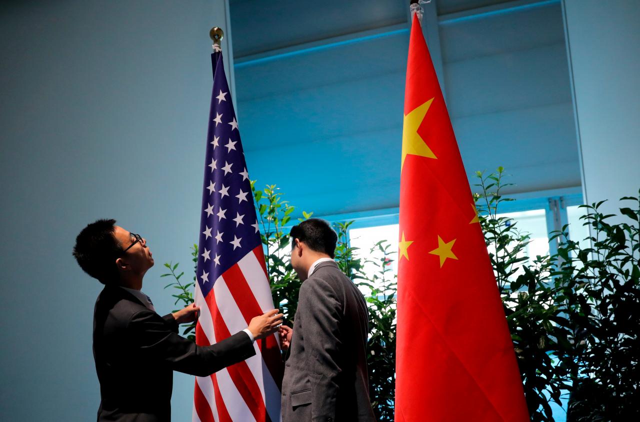 chinese officials prepare the flags for the china us bilateral meeting at the g20 leaders summit in hamburg germany july 8 2017 photo reuters