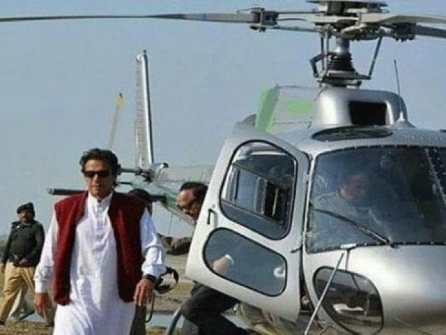 pm imran comes out of a helicopter with police officials in the foreground photo twitter faiqaarshad11