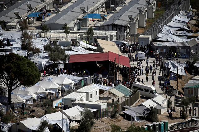 refugees and migrants line up for food distribution at the moria migrant camp on the island of lesbos greece october 6 2016 photo reuters