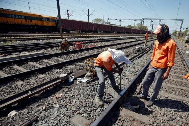 a worker fixes a railway track photo reuters a worker fixes a railway track photo reuters