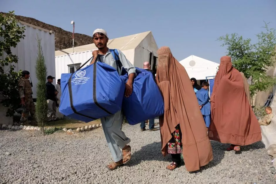 an afghan family who were living as refugees in pakistan carries bundles of supplies at a humanitarian aid station in torkham afghanistan photo reuters an afghan family who were living as refugees in pakistan carries bundles of supplies at a humanitarian aid station in torkham afghanistan photo reuters