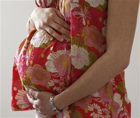 a woman holds her stomach at the last stages of her pregnancy photo reuters