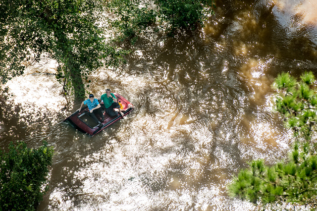 two people sit on the roof of a vehicle trapped in floodwaters from hurricane florence photo afp two people sit on the roof of a vehicle trapped in floodwaters from hurricane florence photo afp