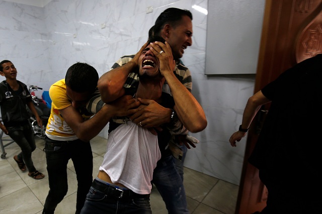 a relative of the two palestinian men who were killed in an israeli air strike the night before mourns in the morgue upon identifying the bodies in khan yunis in the southern gaza strip on september 18 2018 photo afp