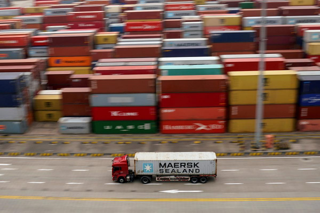a container truck moves past containers at the yangshan deep water port in shanghai china april 24 2018 photo reuters a container truck moves past containers at the yangshan deep water port in shanghai china april 24 2018 photo reuters