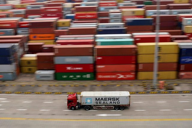 a container truck moves past containers at the yangshan deep water port in shanghai china april 24 2018 photo reuters