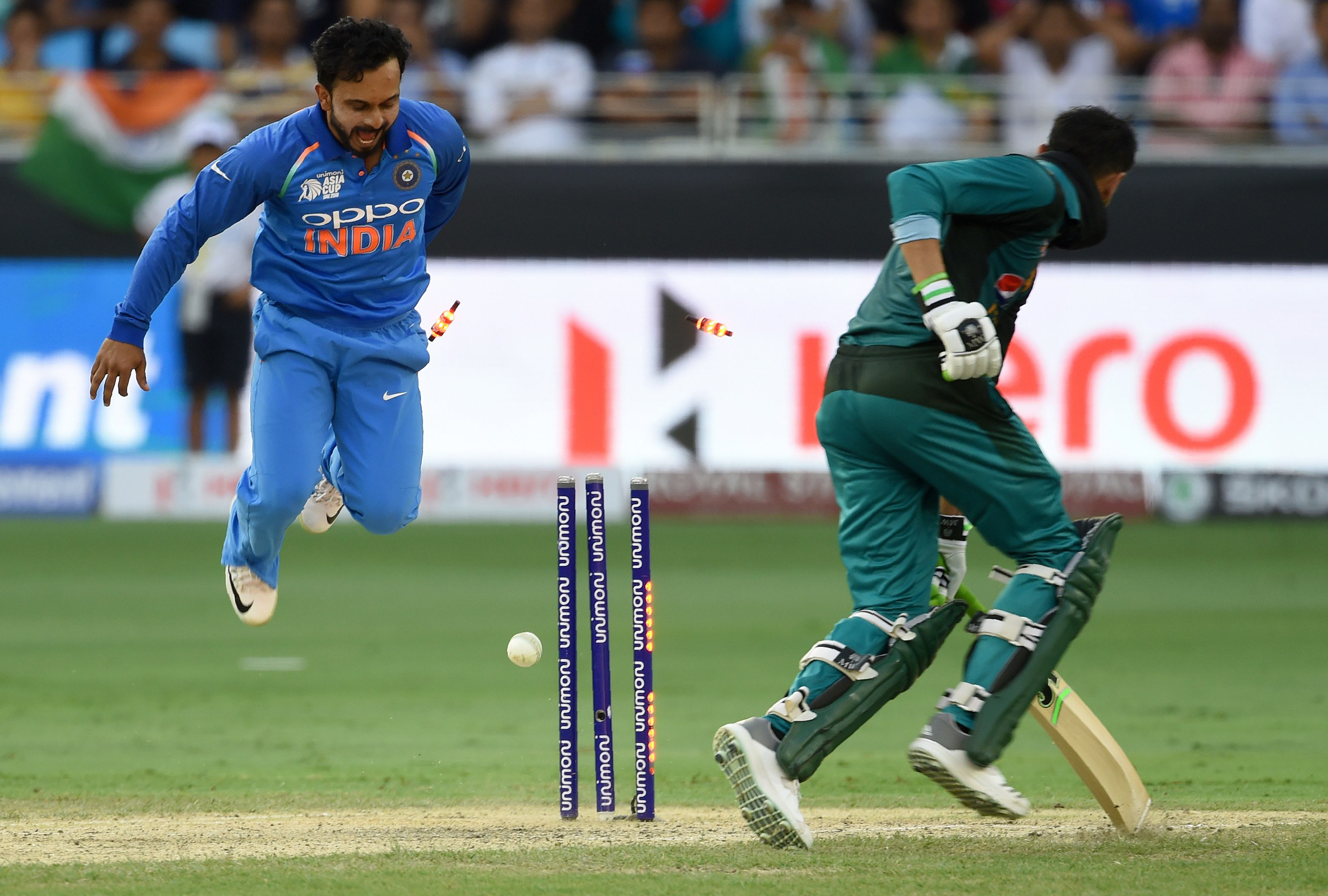 batsman shoaib malik runs out as indian cricketer kedar jadhav l looks on during the one day international odi asia cup cricket match between pakistan and india at the dubai international cricket stadium in dubai on september 19 2018 photo afp