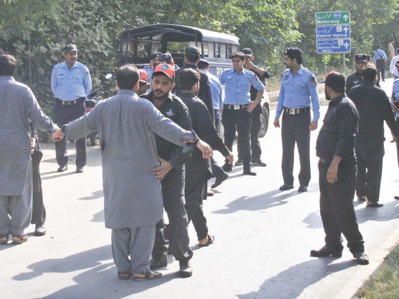 policemen frisk mourners before allowing them to participate in muharram 9 carried out from imambargah jamia al murtaza in sector g 9 photo online