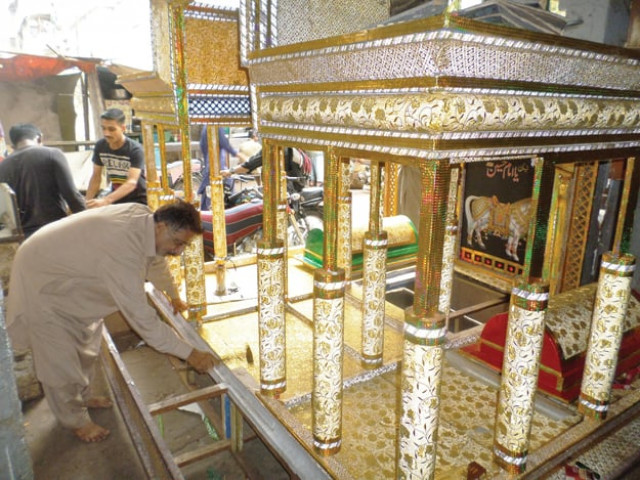 the hindu community members in karachi show their respects for imam hussain ra by adhering to the practices of their elders and engaging in making taziyas which are used in ashura processions photos express