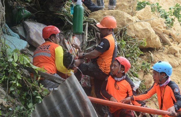 rescuers pull out a survivor from rubble after a landslide in the city of naga cebu philippines photo reuters