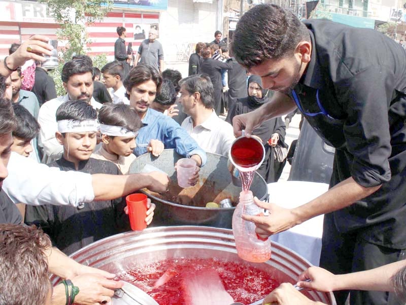 a volunteer distributes sherbet from a sabeel in peshawar photo online