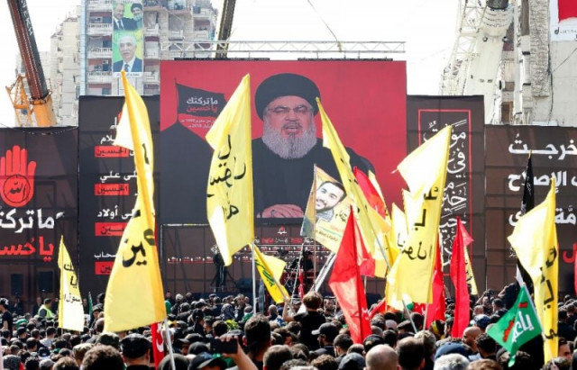 supporters of lebanon 039 s shiite movement hezbollah gather near a poster of their leader hassan nasrallah during a ceremony to mark ashura in beirut photo afp supporters of lebanon 039 s shiite movement hezbollah gather near a poster of their leader hassan nasrallah during a ceremony to mark ashura in beirut photo afp