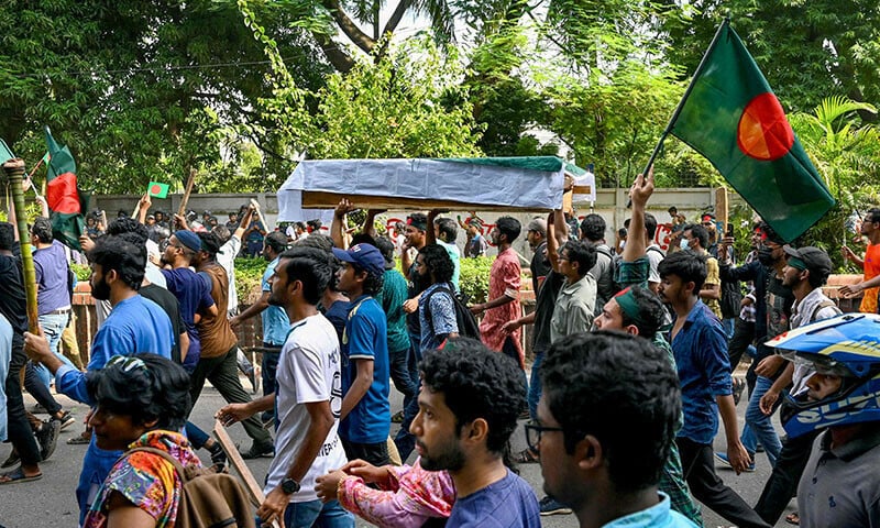 students protesting against quotas in government jobs carry a symbolic coffin of victims a day after they died in a clash with police personnel during an absentee funeral prayer ceremony at dhaka university in the capital photo afp