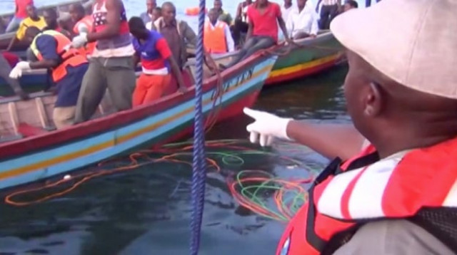 rescue workers are seen at the scene where a ferry overturned in lake victoria tanzania photo reuters