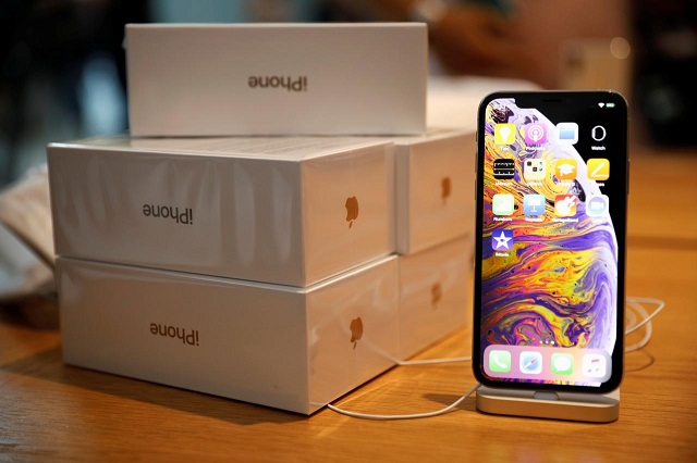 boxes of iphones purchased by customers are pictured next to an iphone xs on display at the apple store in singapore september 21 2018 photo reuters