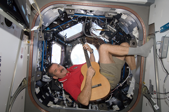 in this nasa file photo taken on december 25 2012 canadian space agency astronaut chris hadfield strums his guitar in the international space station 039 s cupola photo afp