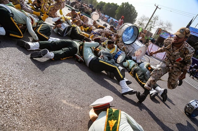 this picture taken on september 22 2018 in the southwestern iranian city of ahvaz shows a soldier running past injured comrades lying on the ground at the scene of an attack on a military parade photo afp this picture taken on september 22 2018 in the southwestern iranian city of ahvaz shows a soldier running past injured comrades lying on the ground at the scene of an attack on a military parade photo afp