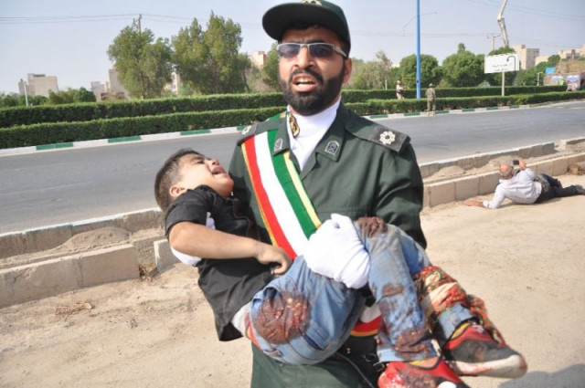 a member of iran 039 s elite revolutionary guards carries away a child wounded in a shooting rampage at a military parade in the southwestern city of ahvaz that foreign minister mohammed javad zarif blamed on a us ally in the region photo afp