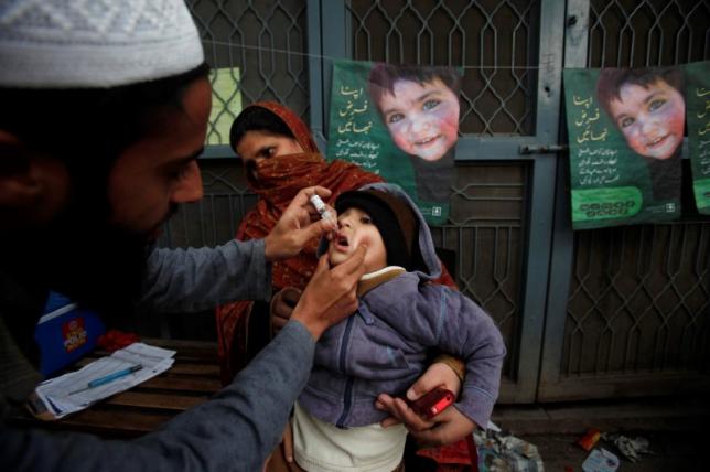 a boy receives polio vaccine drops photo reuters