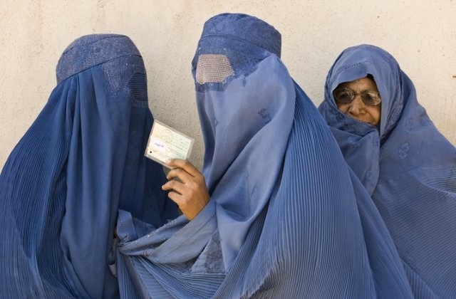 an afghan woman shows her identity card after casting her vote at a polling centre in herat western afghanistan august 20 2009 photo reuters file