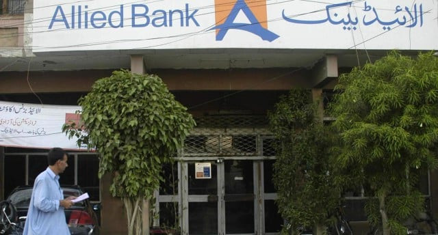 a man walks by an allied bank branch photo express a man walks by an allied bank branch photo express