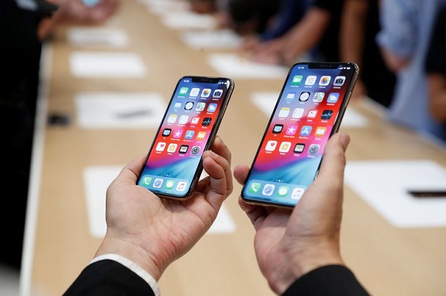 a man holds the newly released apple iphone xs and xs max during a product demonstration following the apple launch event at the steve jobs theater in cupertino california us september 12 2018 photo reuters