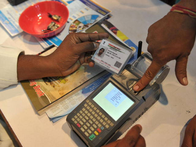 an indian visitor gives a thumb impression to withdraw money from his bank account with his aadhaar or unique identification card photo afp an indian visitor gives a thumb impression to withdraw money from his bank account with his aadhaar or unique identification card photo afp