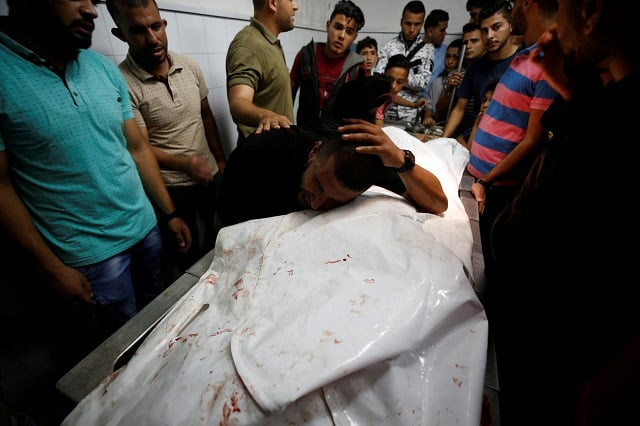 a relative reacts at the body of a palestinian who was killed during a protest at the israel gaza border fence in gaza city photo reuters a relative reacts at the body of a palestinian who was killed during a protest at the israel gaza border fence in gaza city photo reuters