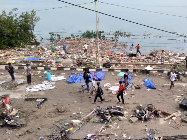 people walk around after palu quake tsunami photo afp people walk around after palu quake tsunami photo afp