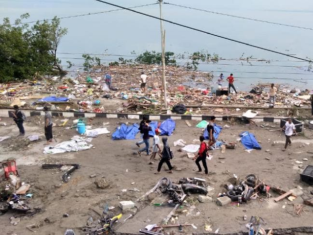 people walk around after palu quake tsunami photo afp