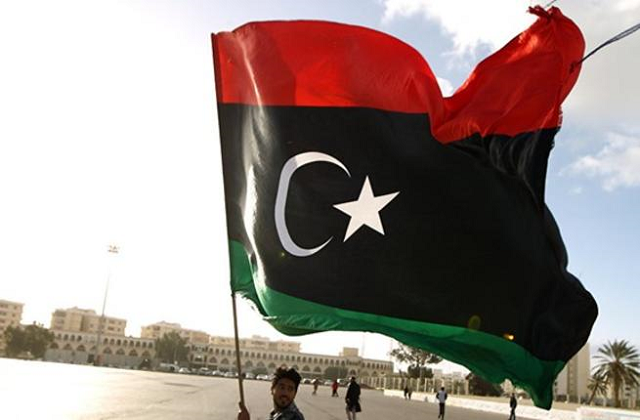 a man waves the libyan flag photo afp