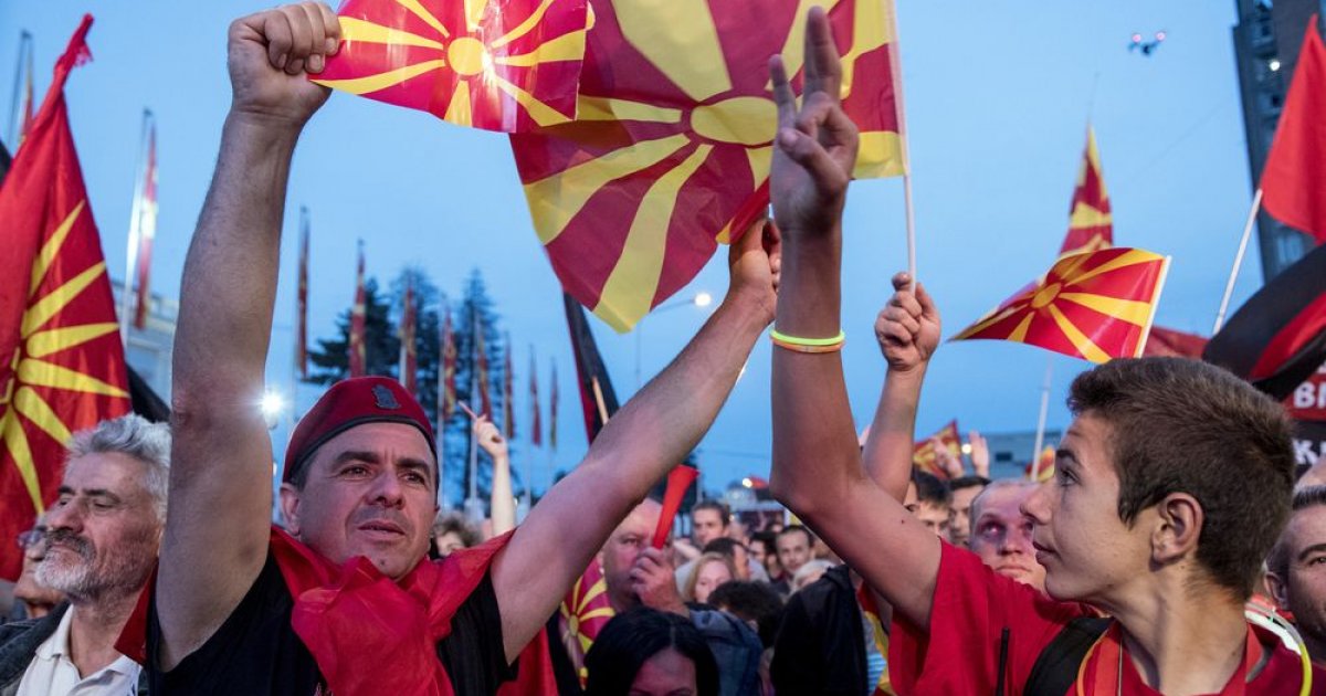 supporters of the biggest opposition party conservative vmro dpmne wave flags during a protest in front of a government building photo afp