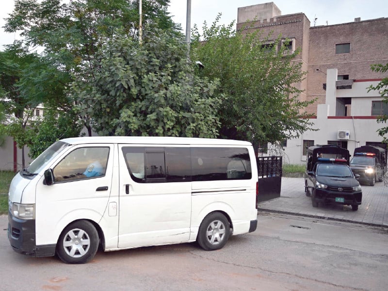 a van carrying arrested pti mnas leave an anti terrorism court in islamabad photo afp