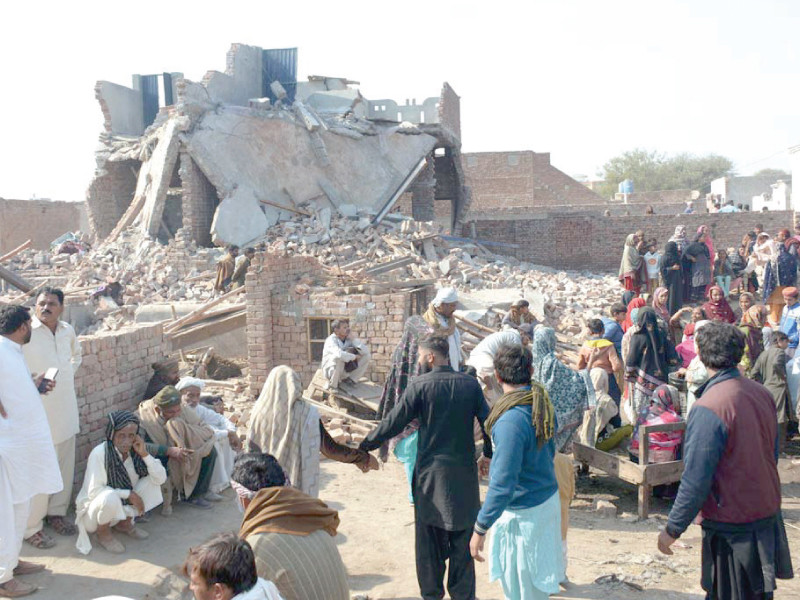 residents gather amidst the debris of their homes destroyed by the explosion of an lpg tanker near an industrial area in multan photo app