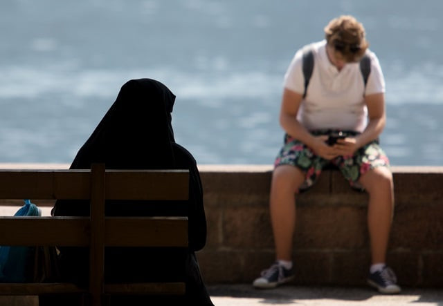 a woman sits on a bench in zell am see austria on august 6 2018 photo afp a woman sits on a bench in zell am see austria on august 6 2018 photo afp
