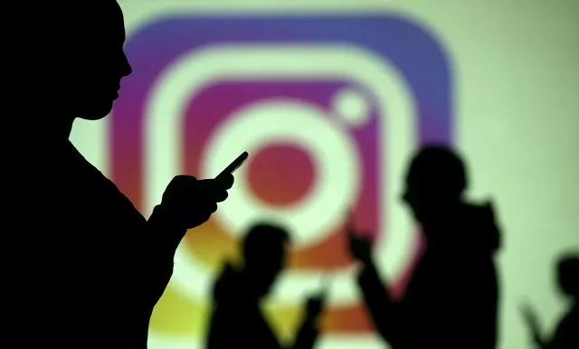silhouettes of mobile users are seen next to a screen projection of instagram logo in this picture illustration taken march 28 2018 photo reuters silhouettes of mobile users are seen next to a screen projection of instagram logo in this picture illustration taken march 28 2018 photo reuters