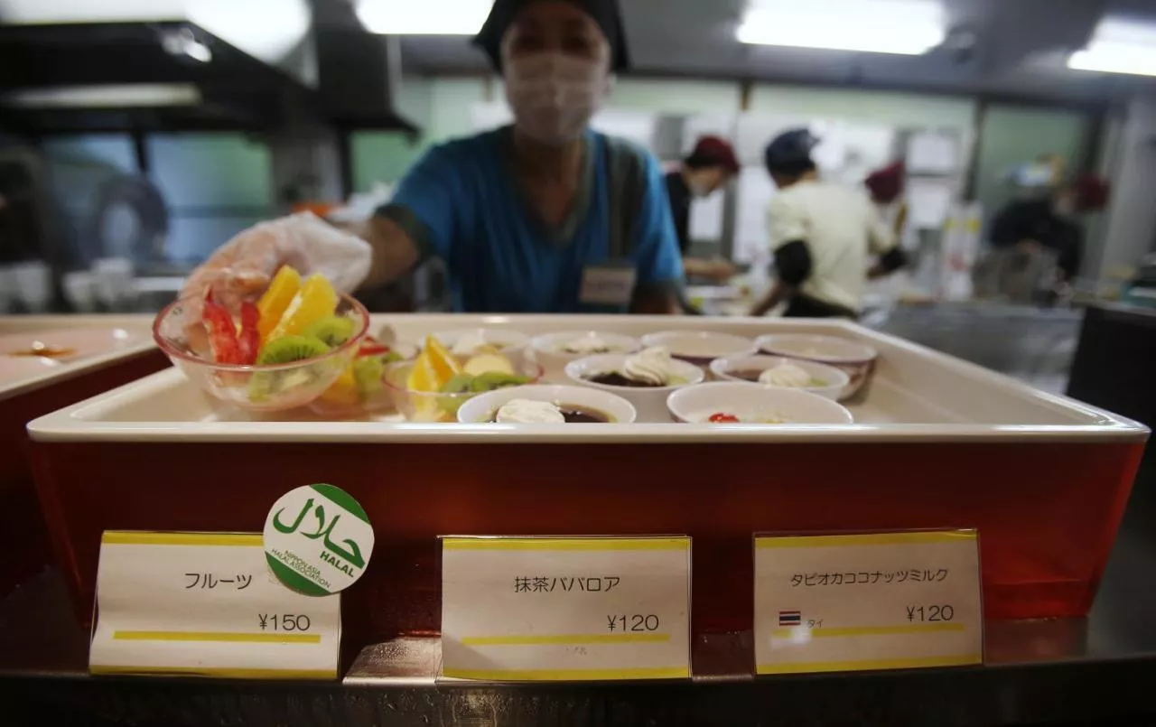 a staff shows a bowl of cut fruit above a quot halal certified quot sign at a dining hall photo reuters a staff shows a bowl of cut fruit above a quot halal certified quot sign at a dining hall photo reuters
