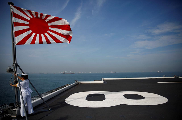 a sailor raises the japanese naval ensign on the deck of japanese helicopter carrier kaga before its departure for naval drills in the indian ocean indonesia september 22 2018 photo reuters a sailor raises the japanese naval ensign on the deck of japanese helicopter carrier kaga before its departure for naval drills in the indian ocean indonesia september 22 2018 photo reuters