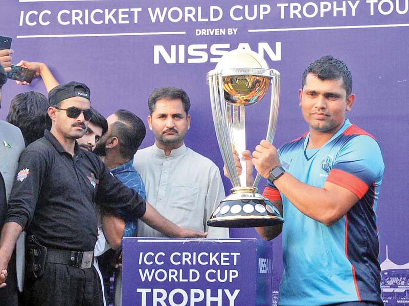 cricketer kamran akmal holding the 2018 icc world cup trophy photo app