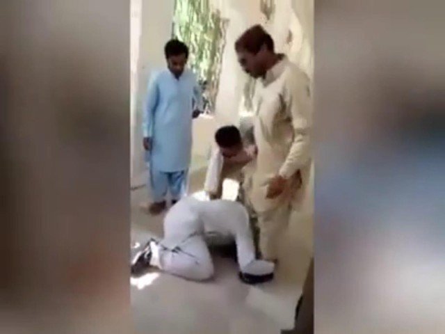 the girl 039 s father who had come to the new saeedabad government degree college for admission from the senior college clerk janib keerio is made to plead on his knees to him screengrab express