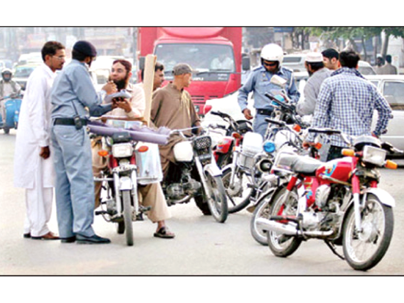 traffic wardens stopping commuters to ask for documents in rawalpindi photo file