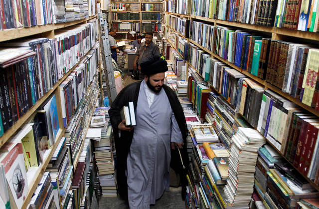 a man walks among books shelves at the howeish book market in the iraqi city of najaf photo afp a man walks among books shelves at the howeish book market in the iraqi city of najaf photo afp