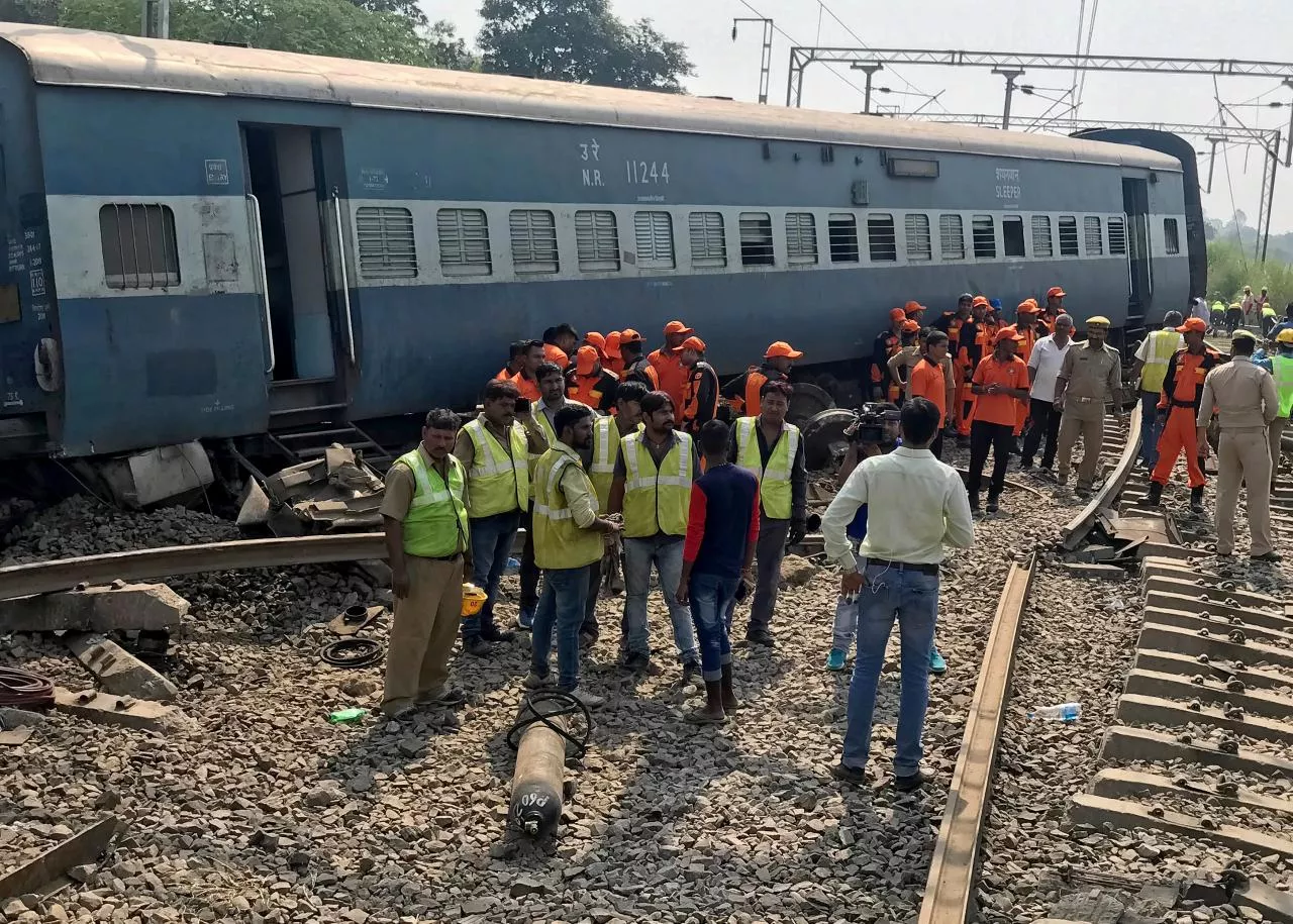 rescuers stand besides a damaged coach of a passenger train after it derailed in harchandpur in the northern state of uttar pradesh india october 10 2018 photo reuters rescuers stand besides a damaged coach of a passenger train after it derailed in harchandpur in the northern state of uttar pradesh india october 10 2018 photo reuters