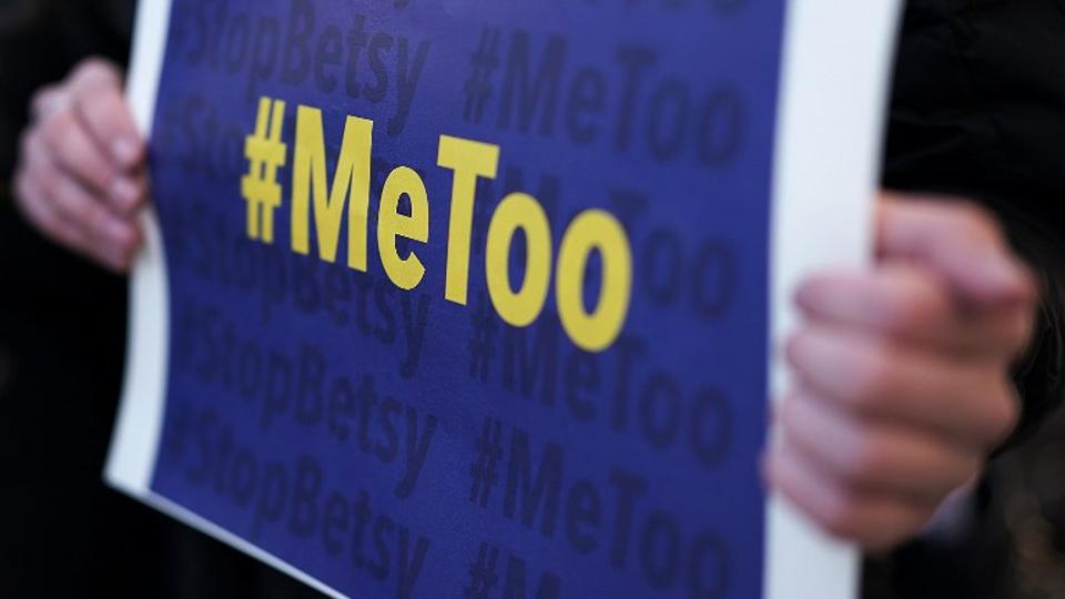 a protester holds up a quot metoo quot poster photo afp