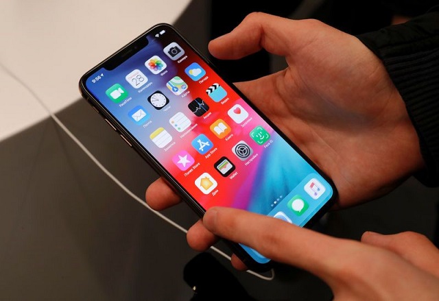 a customer tests a smartphone during the launch of the new iphone xs and xs max sales at quot re store quot apple reseller shop in moscow russia september 28 2018 photo reuters