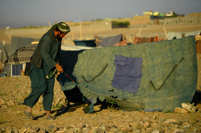 a man fixes his tent photo afp