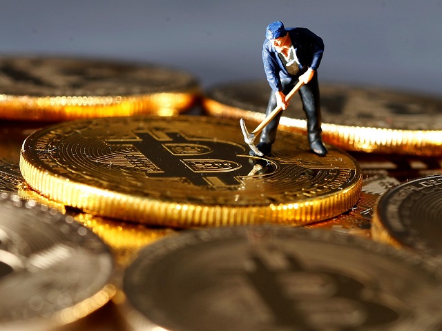 a small toy figure is seen on representations of the bitcoin virtual currency in this illustration picture december 26 2017 photo reuters